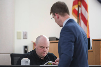 Deputy Chief Assistant Attorney General John Darnall stands before the judge