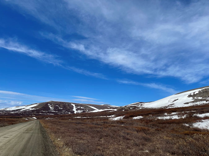 A dirt road and rolling tundra in Nome, Alaska