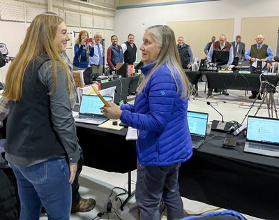 Left to Right: Natalie Weber,  ADF&G Regulations Program Coordinator, greets Senior Assistant Attorney  General Cheryl Brooking with her award at recent Board of Game meeting.