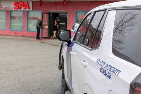 An Alaska State Trooper patrol vehicle is parked outside Jasmine Spa during a search warrant service.